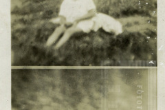 Criança sentada na grama