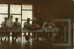 Homens sentados em uma mesa almoçando no evento